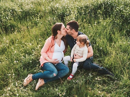A family-style maternity photo.