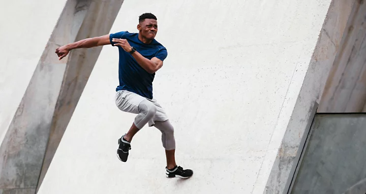 A photo of a person doing parkour, taken using a high shutter speed with shutter priority.