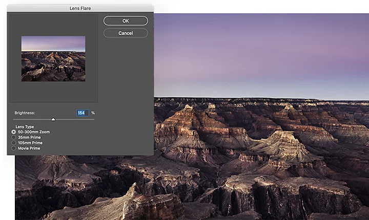 Das Einstellungsfenster für Blendenflecken in Adobe Photoshop über einer Luftaufnahme eines felsigen Canyons