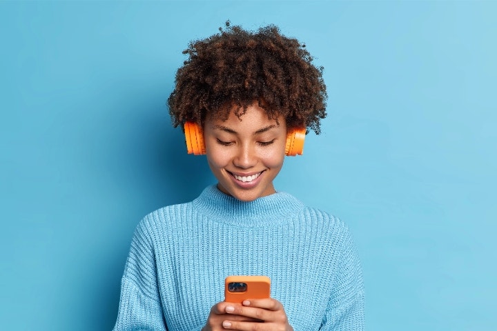 Frau hört Musik mit Wireless Kopfhörern.