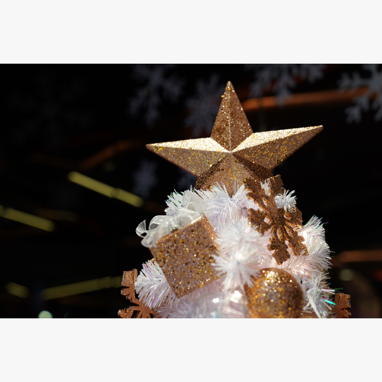 A gold star on top of a white christmas tree AI-generated content may be incorrect.