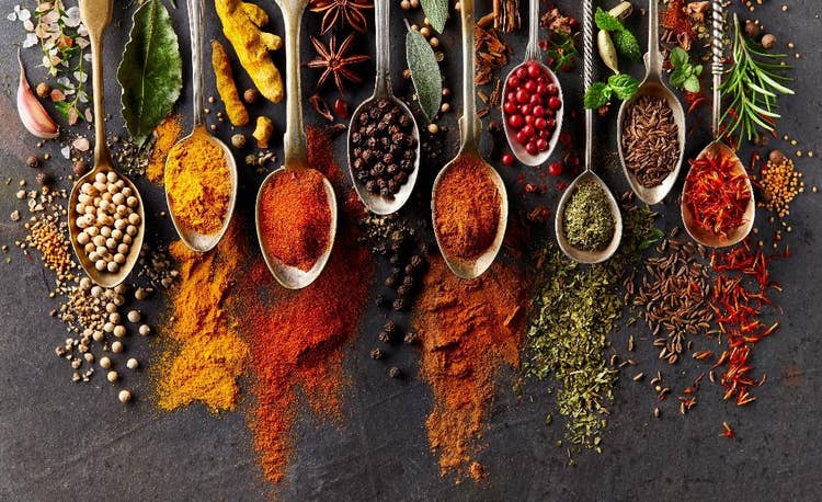 A group of spoons with different spices Description automatically generated