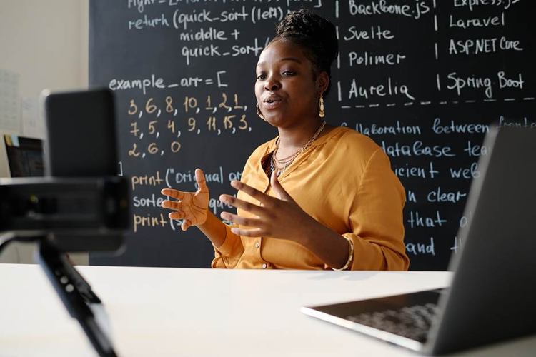 A person in front of a blackboard AI-generated content may be incorrect.