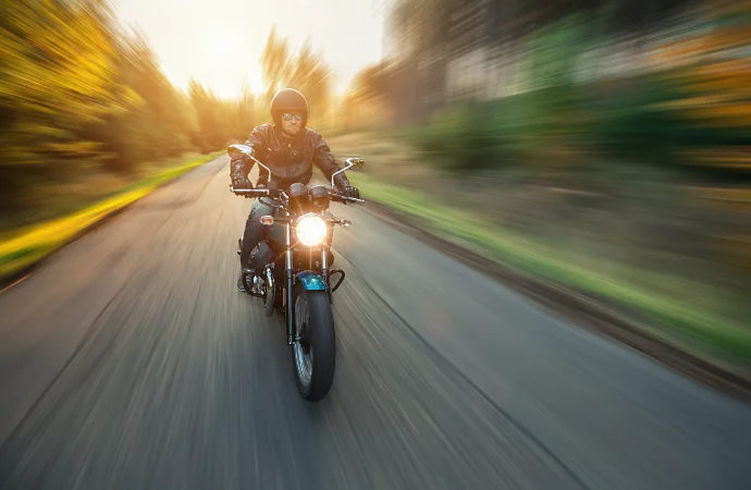 Motorradfahrende Person auf der Straße mit Gaußschem Weichzeichner