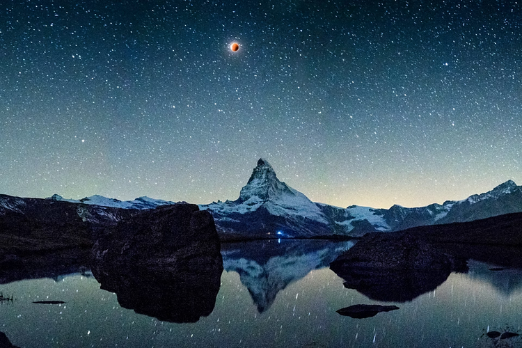 Mountains tower over a coastal village in this landscape photo