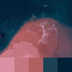 A color palette created from an image of a pink sand beach with dark blue water