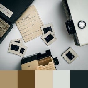 A color palette created from an image of a vintage projector and old paper against a white background
