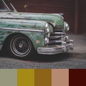 A color palette created from an image of an vintage rusty green car against a dark wooden background