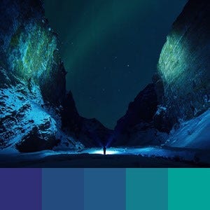 A color palette created from an image of mountains at night with a person in the distance shining a light creating blue and green shadows
