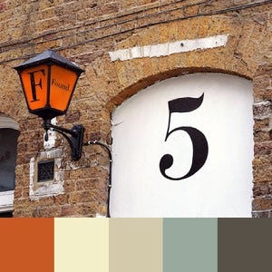 A color palette created from an image of a brown brick wall with a painted white section and an orange lamp post