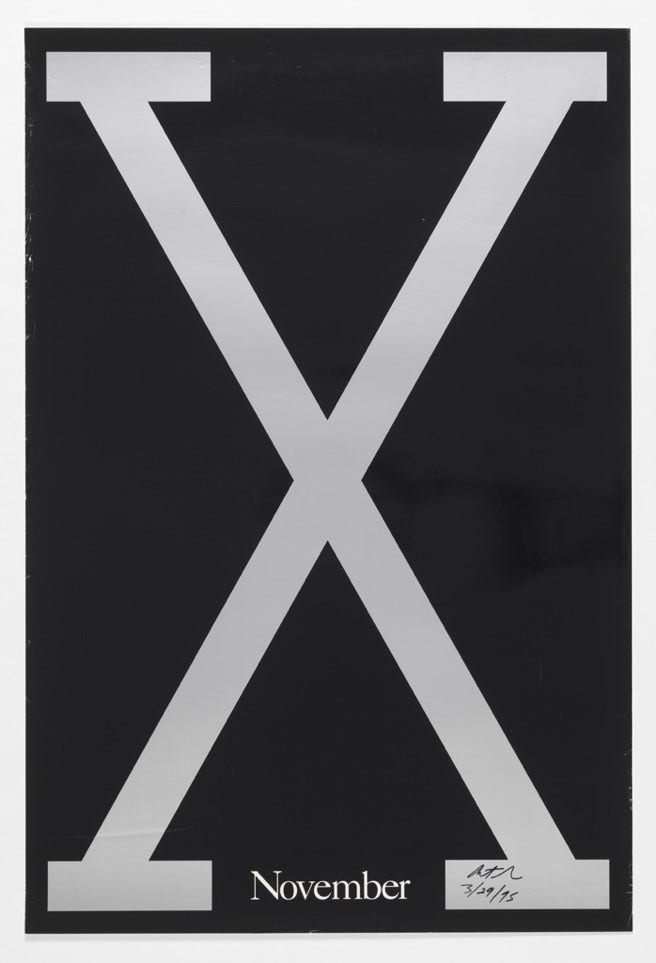 A silver X filling a black background. At the middle base is a smaller text that reads, "November."