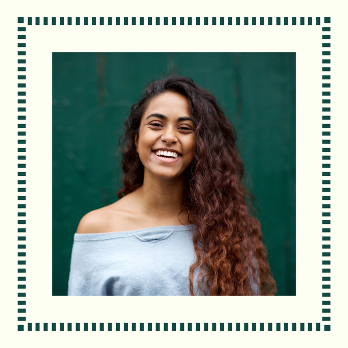 Instagram profile picture of a person with long wavy hair smiling against a dark green background