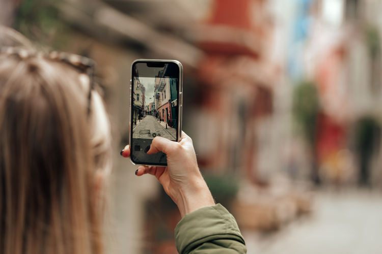 A person takes a photo on a smartphone.