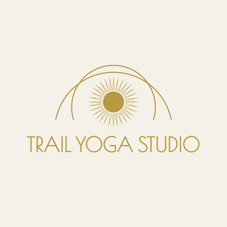 Trail Yoga Studio text and icon logo in the font Poiret One with an abstract icon of a sun surrounded by concentric circles