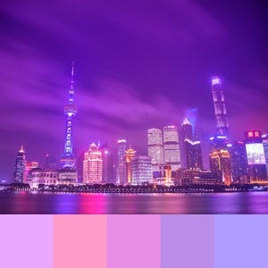 A color palette created from an image of a city in the evening with a purple hue with the buildings reflecting on water