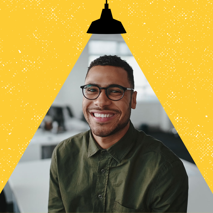 Instagram profile picture of a person with glasses and short hair smiling with a hanging light icon above shining