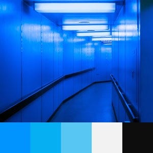 A color palette created of an image of a lit up blue hallway with black handrails