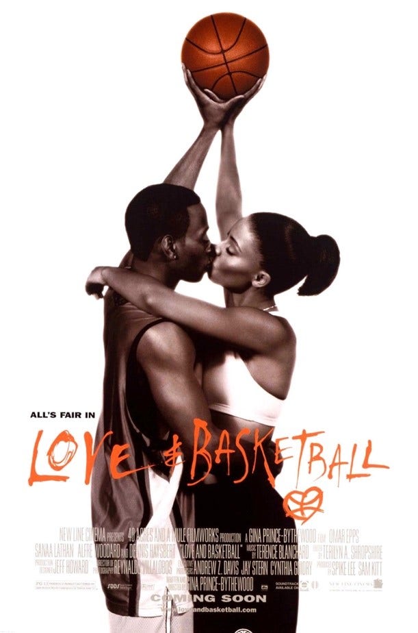 A Black man and a Black woman kissing while they both hodl up a basketball.