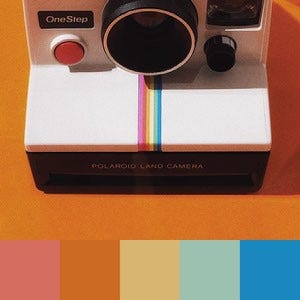 A color palette created from an image of a polaroid camera with a rainbow stripe against an orange background