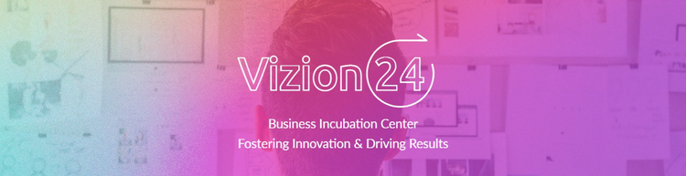A LinkedIn background photo for Vizion 24 with an image of a person's workspace in the background