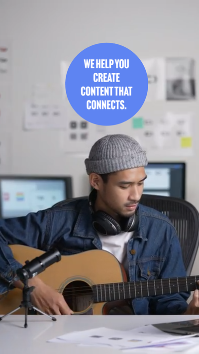 Image of a guy in a gray wool cap playing the guitar