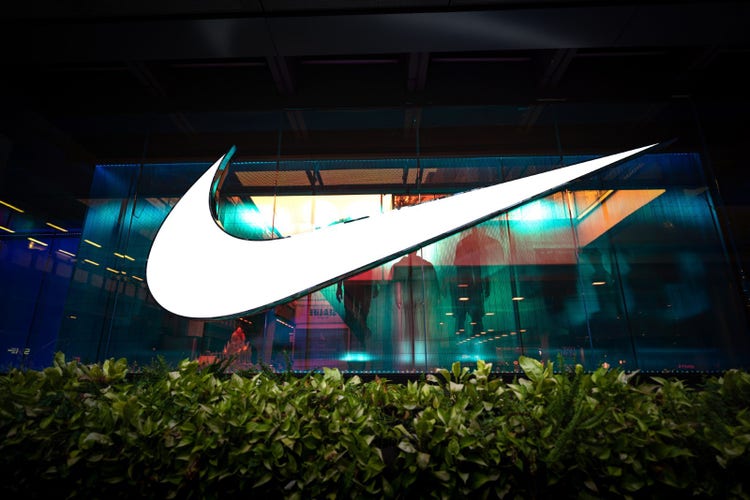 A Nike store with a giant Nike logo in front