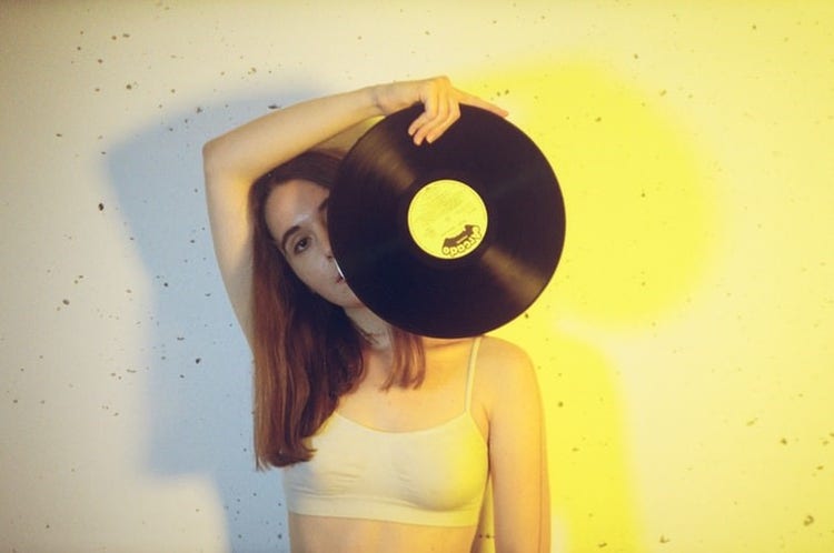 A girl holding a cd plaque