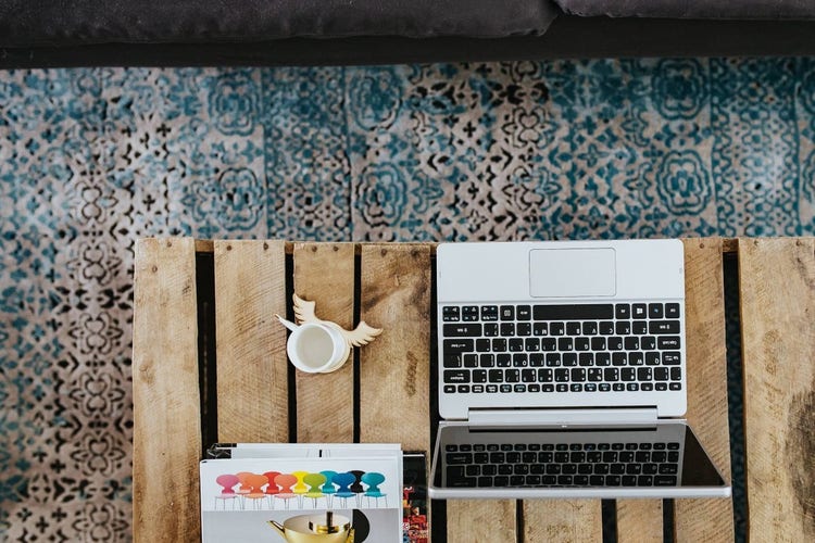Laptop and cup on a wooden box