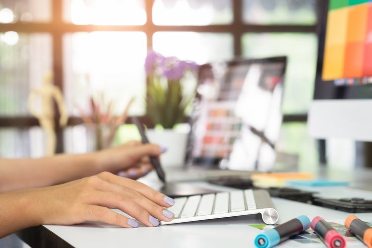 Person touches Mac keyboard with lavender nails