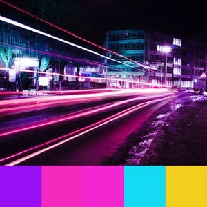 A color palette created from an long exposure image of pink and purple neon vehicle lights on a street at night with blue tinted buildings