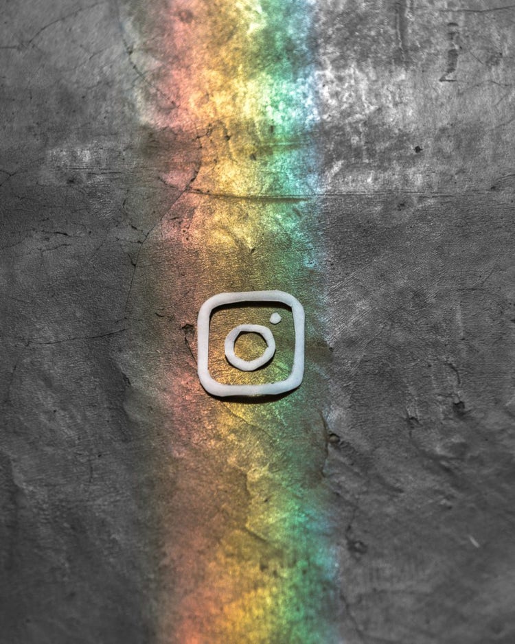 Instagram icon made of clay over rainbow design