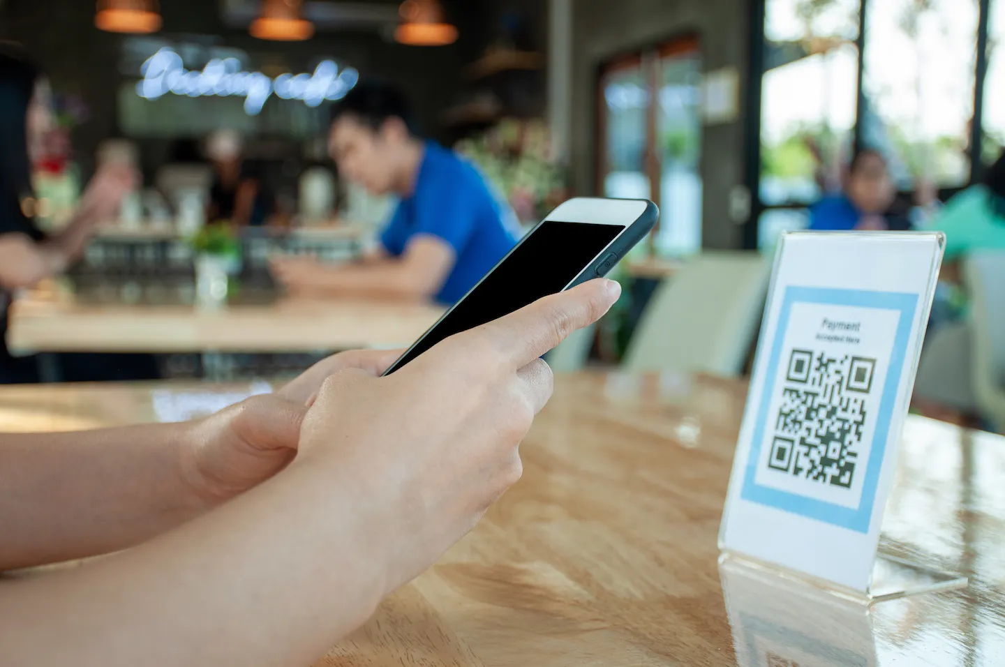 How to go Contactless (for businesses) woman using phone to scan the QR code