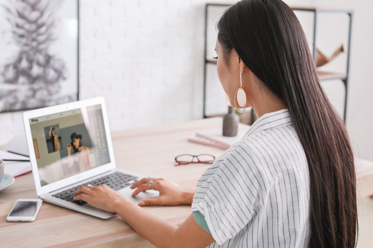 Woman at her desk on her laptop