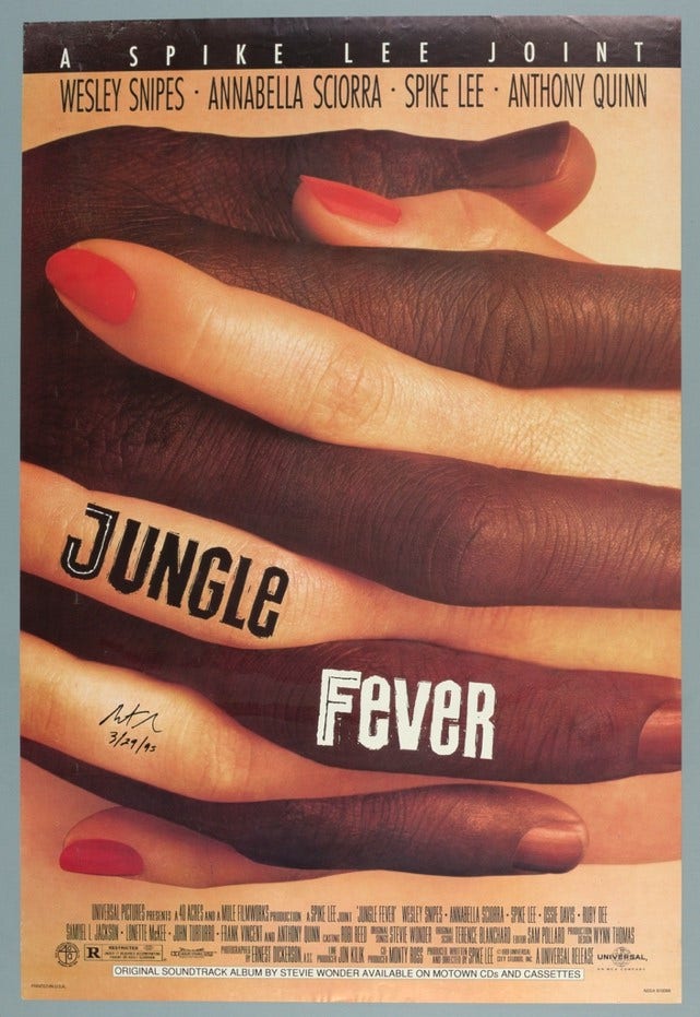 A Black hand and a white hand with red painted nails hold each other. The title "Jungle Fever" is printed across the fingers.