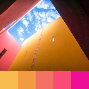 A color palette created from an upward image of a yellow and pink building with a partly cloudy sky