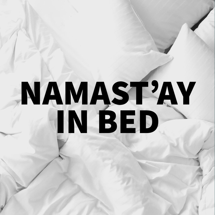 "namast'ay in bed" Instagram post against a background of white bedding and sheets