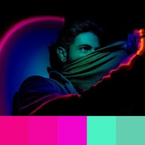 A color palette created from an image of a person with neon pink and green lights being reflected onto them