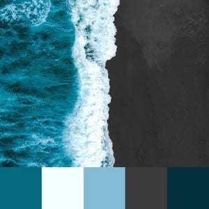 A color palette created from an image of the ocean meeting a dark grey sand beach with white sea foam