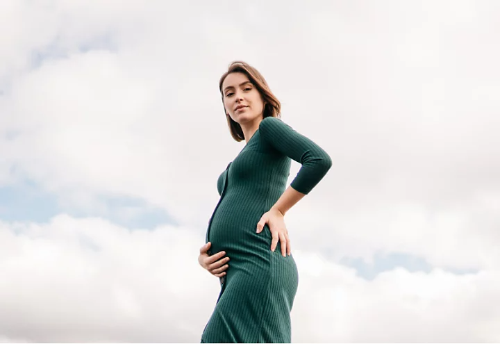 A silhouette-style maternity portrait photo.