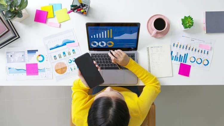 A person sitting at a desk using a computer AI-generated content may be incorrect.