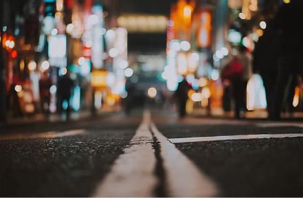 Cracked surface of a city road captured at night