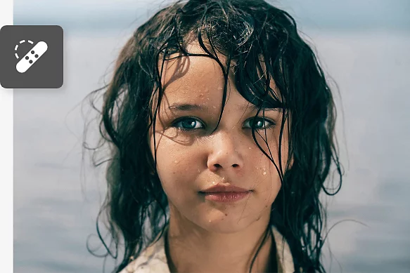 Το εικονίδιο του εργαλείου Spot Healing Brush υπερτίθεται σε μια φωτογραφία πορτρέτου του προσώπου ενός ατόμου.