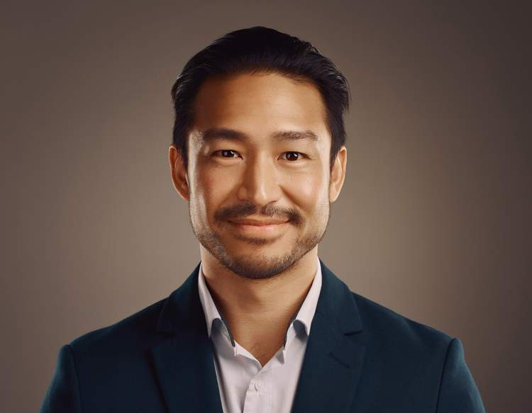 Headshot of a man against a serene studio backdrop