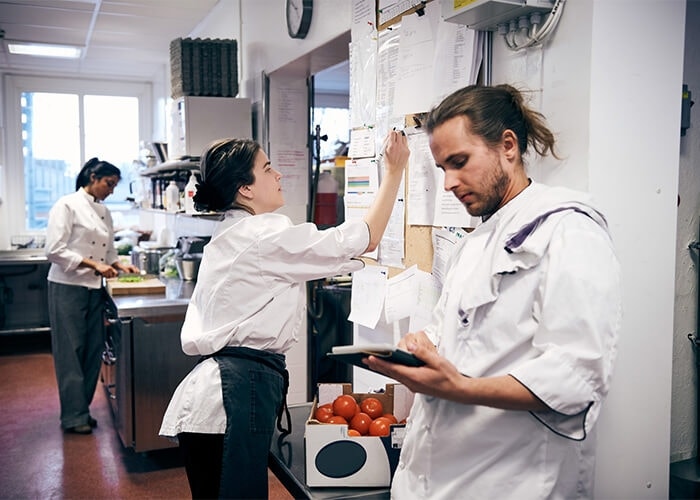 A chef reviews safety information on their tablet