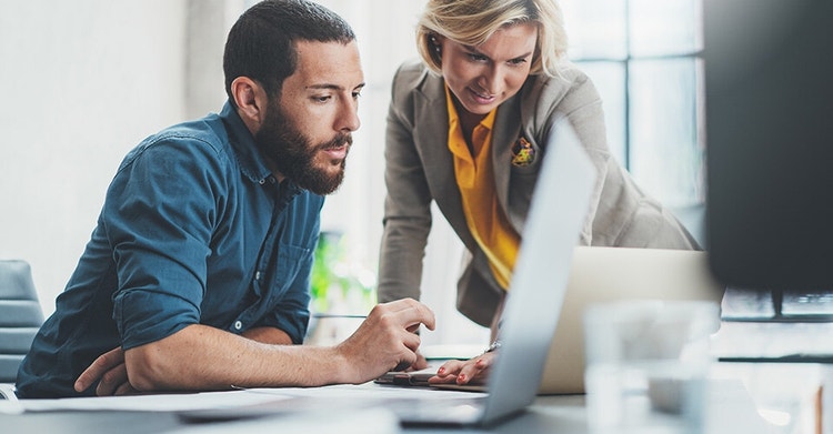 Business colleagues reviewing business data together