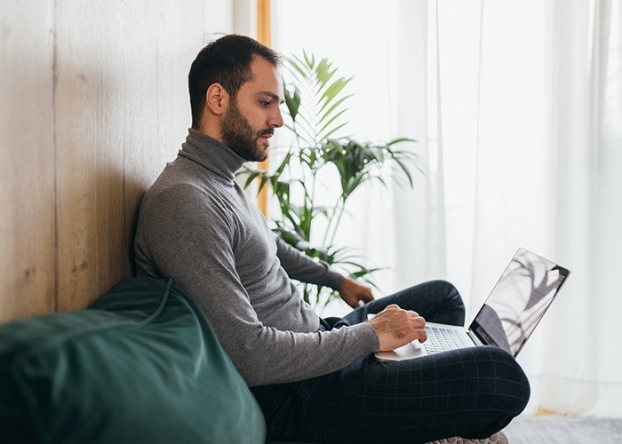 Person sitting and working on their computer editing a PDF