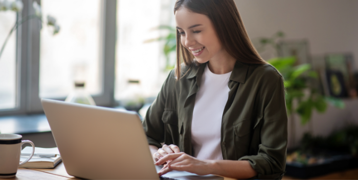 Woman smiling while using a computer to search a PDF.