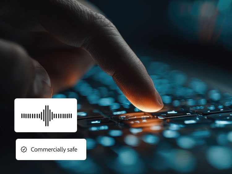 Gambar close-up sebuah jari sedang menekan tombol komputer disertai overlay gelombang audio dan lencana yang menyatakan bahwa audio yang dihasilkan "Aman untuk penggunaan komersial."