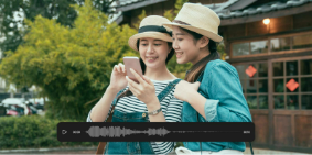 Two travelers use an audio translator on a smartphone showing translate audio waveform while exploring a new destination.