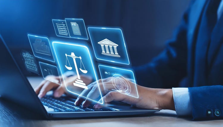 A person hand is typing on a laptop overlaying a holographic image showing various legal icons.